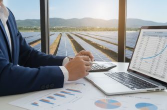 A detailed and photorealistic image depicting the financial analysis of a solar power plant’s return on investment. In the foreground, illustrate a professional business person, dressed in business attire, analyzing spreadsheets and graphs on a laptop with a calculator beside them. In the middle ground, include a large solar panel installation bathed in natural sunlight, showcasing rows of solar panels with a clear blue sky above. The background features a rolling landscape with green hills, symbolizing sustainability. Use soft, natural lighting to create a professional and positive atmosphere. Ensure the focus on the analysis process, with close-up details of graphs indicating cost-efficiency, donning a typical business environment that conveys a sense of diligence and seriousness toward investment in renewable energy.